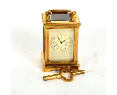 A reproduction miniature brass-cased carriage clock, height 6cm 