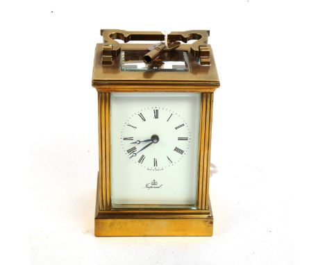 An Imperial brass-cased carriage clock, white enamel dial with Roman numeral hour markers and glass exhibition plates, case h