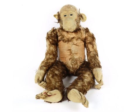 A large Vintage straw-filled monkey toy, possibly Steiff, height 70cm 