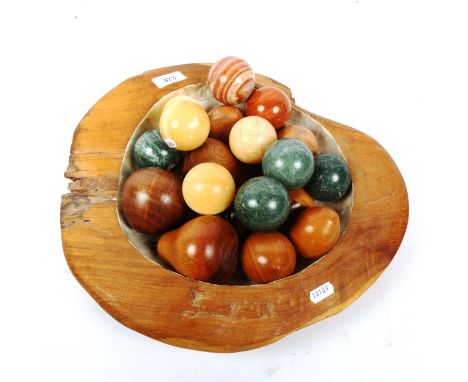 A group of polished hardstone orbs, carved hardwood fruit, mother-of-pearl mounted fruit bowl etc 