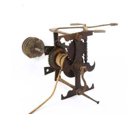 An 18th century wrought-iron country house spit roasting engine jack, with weight driven movement and forged iron fireplace c
