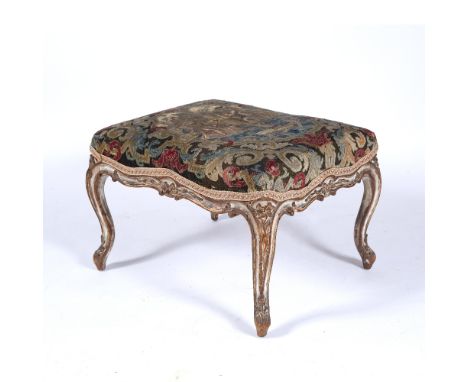 Carved and painted beechwood stool French, 18th Century, with 17th/18th Century tapestry cover, on shaped supports, 69cm acro
