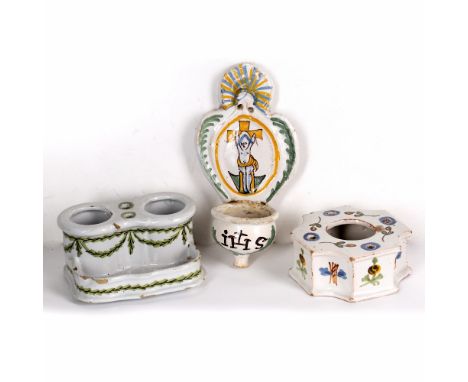 Three faience items 18th Century, comprising a French benetier with the Crucifixion, a French inkwell and a German inkstand (
