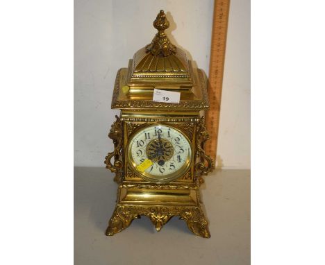 Early 20th Century brass cased mantel clock with lion mask handles, movement lacking