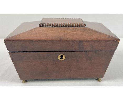 A vintage mahogany sarcophagus caddy with brass feet and escutcheon. Interior lined with green baize and with lift out tray. 