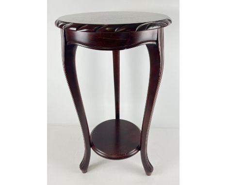 A modern mahogany coloured circular jardiniere/lamp stand with shaped legs and carved edging. Approx. 75cm tall x 42cm diamet