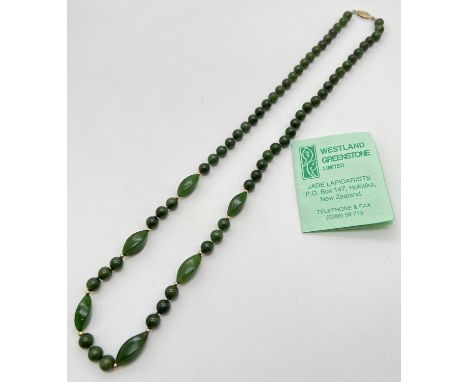 A 27" Nephrite green jade necklace made from round and marquise shaped beads. With gold tone pierced work clasp. Complete wit