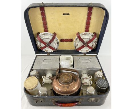 A cased 1930's Brexton picnic set. Contents include matching cups, saucers, teapot and sandwich plates, copper kettle, solid 