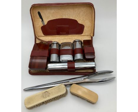 A vintage leather cased chrome and wood men's vanity set with zip fastening. Together with 2 small bone backed brushes and a 
