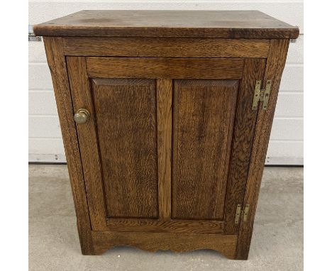 A vintage dark oak cupboard with brass knob handle and interior shelf. Panelled door with push catch. Approx. 74cm tall x 58.