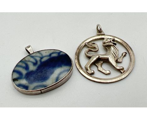 2 vintage silver pendants. A circular shaped lion pendant, fully hallmarked to reverse, and a blue &amp; white ceramic pendan