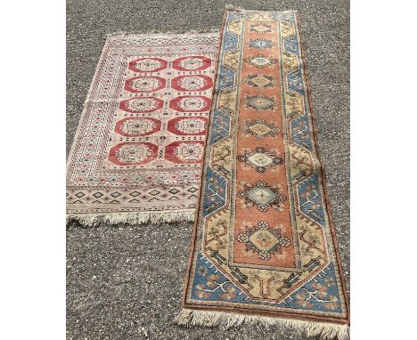 2 vintage Indian style rugs. A beige ground tassled ended rug with geometric style design together with an orange blue and be