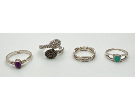 4 silver dress rings. An illusion diamond set in a twist design, a central oval cut amethyst, central round turquoise and a t