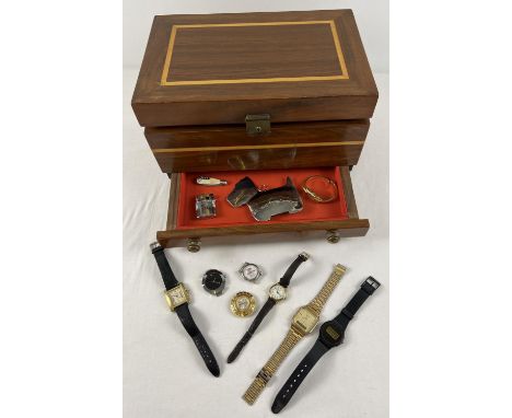 A wooden jewellery box with inlaid detail to lid and body containing a small collection of wristwatches and misc item. Watche