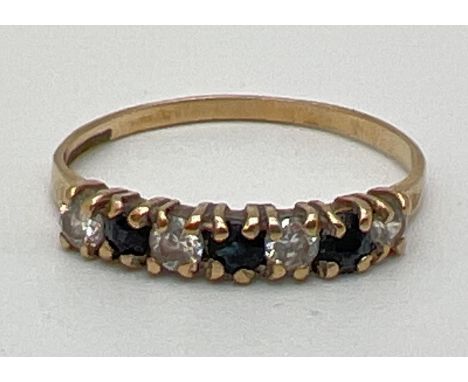 A 9ct yellow gold, sapphire &amp; clear stone half eternity ring. Fully hallmarked inside band. Ring size M. 