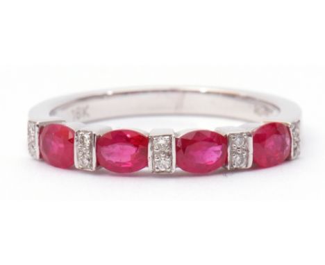Modern ruby and diamond half-hoop ring, a design featuring 4 oval faceted rubies between 5 pairs of small single cut diamonds