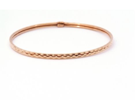 9ct gold bangle with a continuous stylised engraved design, 7cm diam, 3.6gms