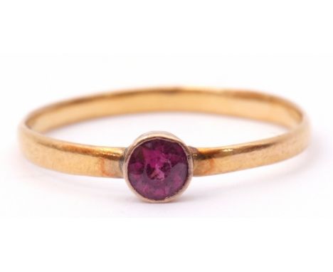 Antique 22ct gold ring with a small circular pink ruby in a collet setting, to a plain polished shank, size T