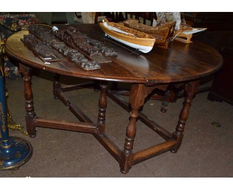 An 18th-century oak gate leg table 168cm by 152cm by 73cm