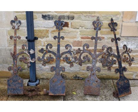 A set of four Victorian cast iron gate brackets of scrolling form with stylised fleur-de-lys terminals, 44cm by 56cm (a.f)Con