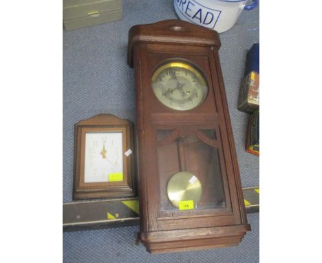 An early 20th century oak wall hanging 8 day clock, together with a quartz clock 