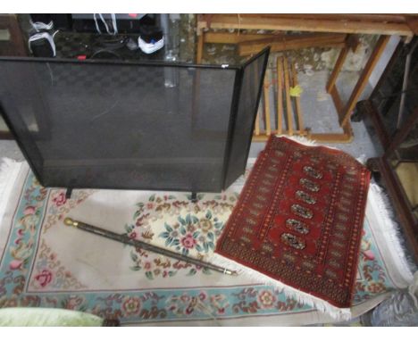 A Chinese washing woollen rug and a Bokhara mat, a Middle Eastern mat, along with a fireguard and walking stick/snooker cueLo