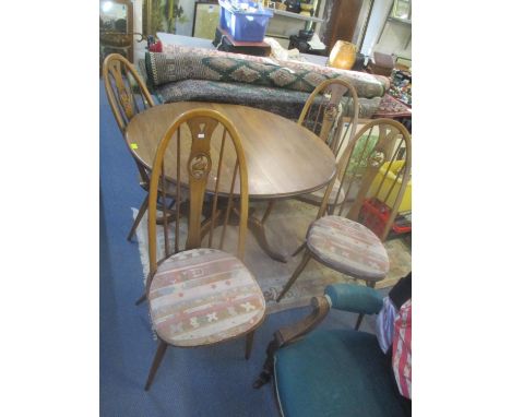 An Ercol Golden Dawn extending dining table, together with four Quaker Swan chairs 