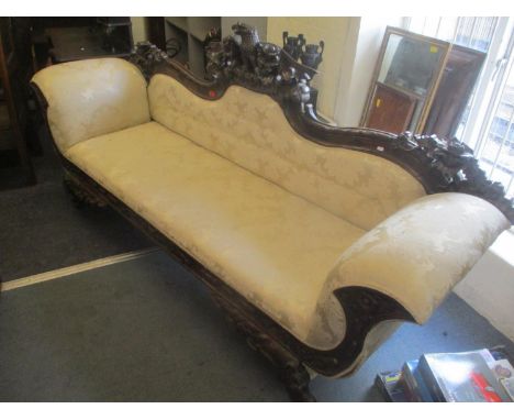 A reproduction 19th century style mahogany double end sofa having a carved eagle to the centre flanked by pierced floral deco