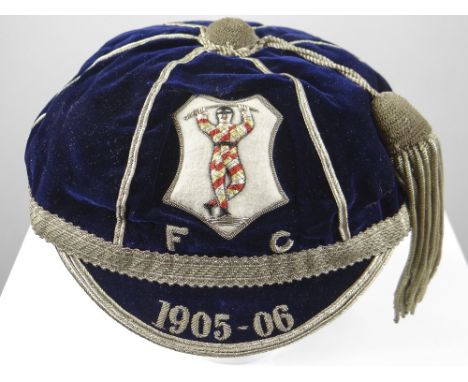 A HARLEQUIN RUGBY UNION FOOTBALL CLUB CAP AWARDED TO JOHN GUY GILBERNE BIRKETT (1884-1967) The cap in deep blue felt and of t