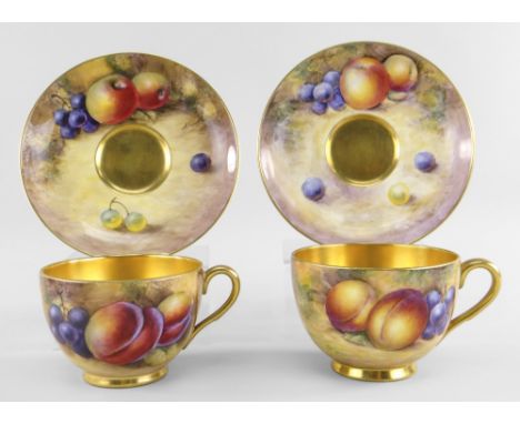 TWO ROYAL WORCESTER PORCELAIN CABINET TEA CUPS &amp; SAUCERS, painted with apples, plums and grapes by Alan Telford and John 