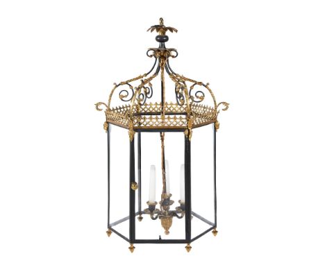  A Regency style gilt and patinated brass hall lantern,   with a  three light hanging fixture, with scrolling supports rising
