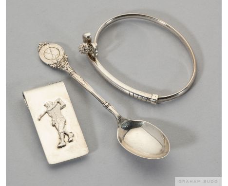 A silver golf bangle, modelled&nbsp;as a club and ball&nbsp;in case,  sold with a silver money clip decorated with a figure o
