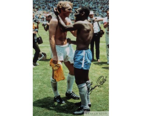 A large colour portrait photograph of the famous embrace between Pele and Bobby Moore at the 1970 Mexico World Cup Finals, si