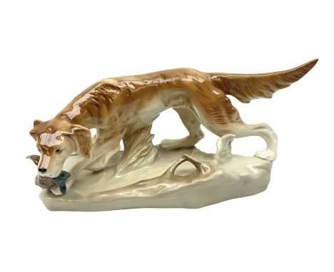 Royal Dux porcelain hunting dog with a bird, printed mark beneath, L36cm