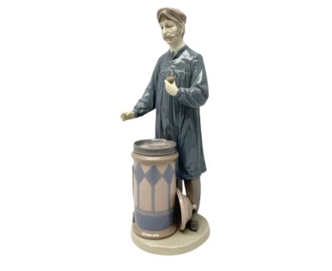 Lladro figure, 'Predicting the Future', modelled as a male donning hat with pipe standing above a barrel containing a dial wi