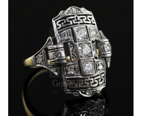 An Art Deco style platinum, yellow gold and diamond set tablet ring, with Greek Key pierced decoration, size L.