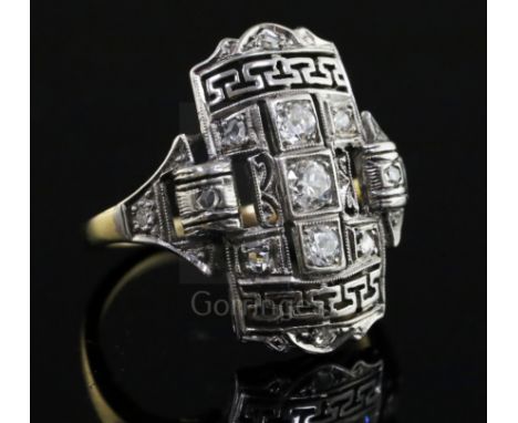 An Art Deco style platinum, yellow gold and diamond set tablet ring, with Greek Key pierced decoration, size L.