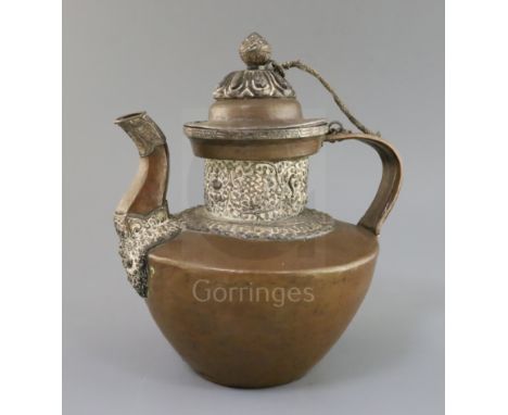 A Tibetan copper and silver teapot, 19th century, the silver boards embossed with the eight Buddhist emblems, plants and foli