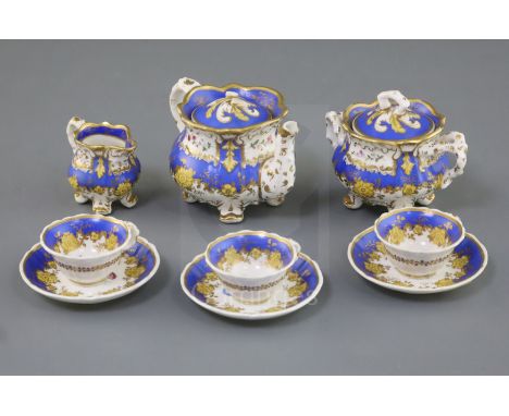 A Rockingham porcelain miniature tea set, c.1830-42, each piece painted with flower sprays within gilt and blue borders, sauc