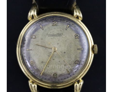 A gentleman's 18ct gold International Watch Co. manual wind wrist watch, with Arabic and baton numerals, on associated leathe