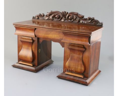 An early Victorian mahogany novelty tea caddy in the form of a twin pedestal sideboard, with three drawers and two canisters,