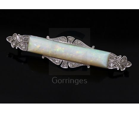 A 1940's/1950's white gold?, white opal and diamond set bar brooch, the opal stone measuring 31mm in length, 49mm.