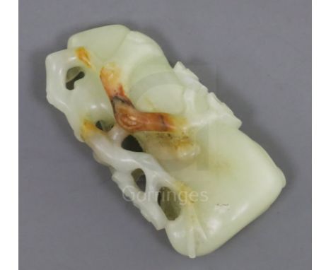 A Chinese pale celadon and russet jade carving of a prunus bough, 5.3cm