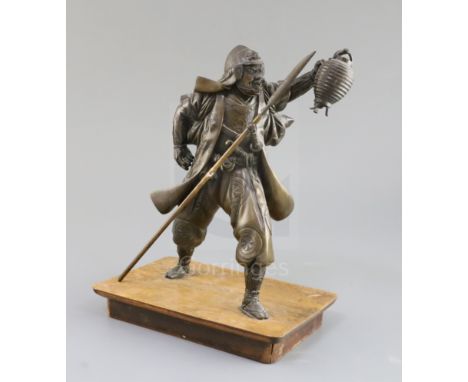 A Japanese bronze figure of a Samurai, Meiji period, the figure holding a lantern in his left hand and a spear in his right, 