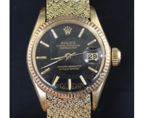 A ladys' 18ct gold Rolex Oyster Perpetual Datejust Superlative Chronometer, having black dial with baton numerals (bracelet r