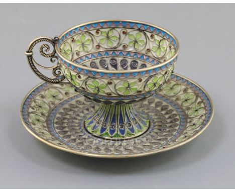 An early 20th century Norwegian silver, enamel and plique a jour cup and saucer, by Marius Hammer, decorated with scrolls and