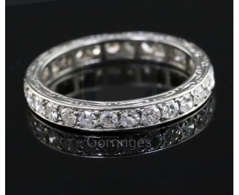 A platinum? and diamond set full eternity ring, with engraved shank and set with twenty eight round cut stones, size K.