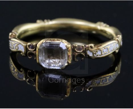 A George II gold, white enamel and rock crystal set mourning ring, with hair beneath the central stone and shank inscribed 'E