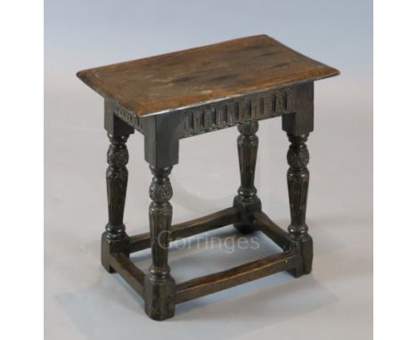 A James I oak joint stool, with lunette carved frieze, carved and fluted legs and all-round stretchers, 1ft. 6in. x 10.75in. 