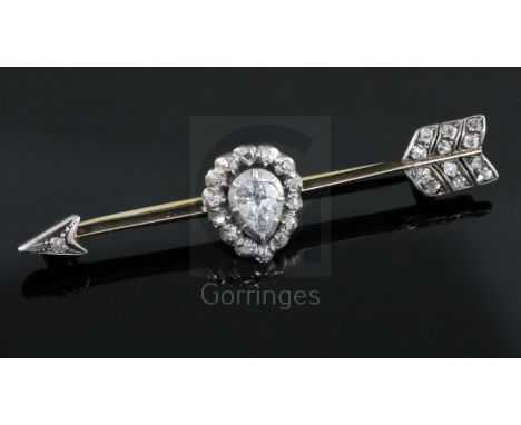 A late Victorian gold and diamond set arrow shaped bar brooch, with central pear shaped diamond, 56mm.